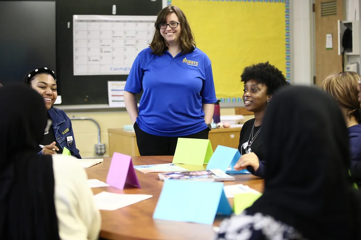 Heights facilitator smiling in front of students