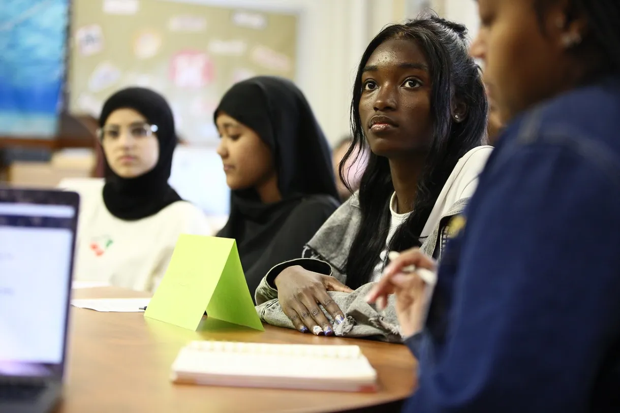 Students at a table in a classroom